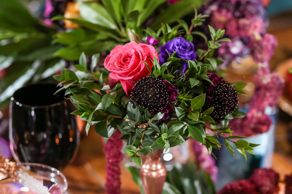 Vibrant Whimsical Wedding Reception Low Centerpiece with Black, Plum, Purple and Pink Florals with Greenery in Copper Candleholder | Tampa Bay Wedding Florist Gabro Event Services