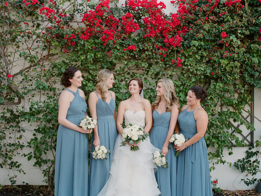 Outdoor Garden Bridal Party Portrait, Bride in Layered Ballgown Strapless Wedding Dress, Bridesmaids in Dusty Blue Mismatched Long Dresses, with White Floral and Greenery Bouquet | Tampa Wedding Venue The Westshore Yacht Club