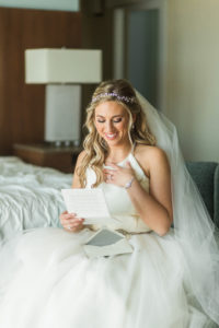 Bride Getting Ready Portrait Reading Letter from Groom, Wearing Halter Hayley Paige Wedding Dress and Jeweled Headpiece