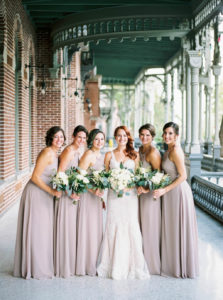 Outdoor Downtown Tampa Bridal Party Portrait, Bride in Column Stella York Wedding Dress, Bridesmaids in Taupe Floor Length Mismatched Azazie Dresses, with White Floral and Greenery Bouquet | Wedding Planner Glitz Events