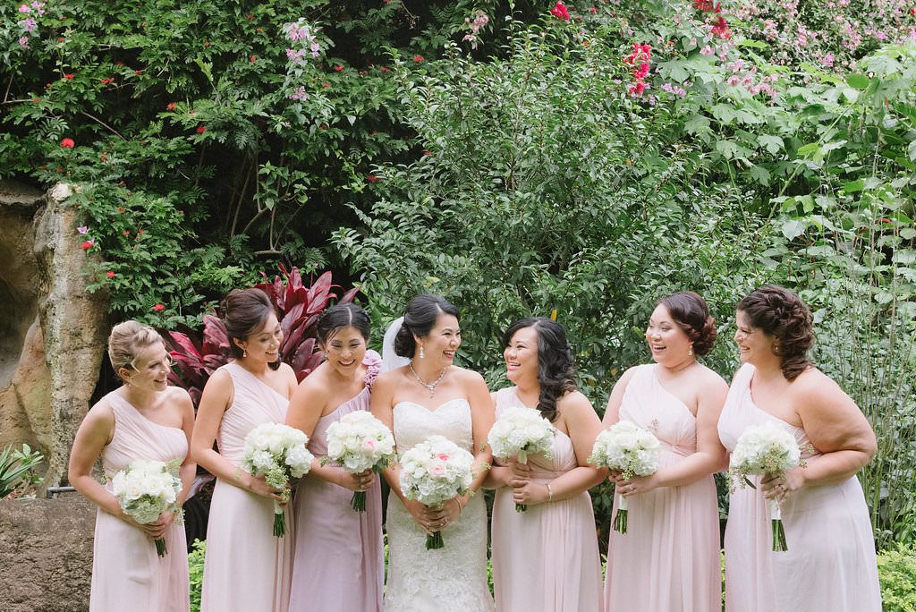 Outdoor Garden Wedding Bridal Party Portrait, Bridesmaids in One Shoulder Blush Pink Dresses, Bride in Strapless Lace Column Wedding Dress, with White and Blush Pink Rose Bouquets | St Pete Wedding Ceremony Venue The Sunken Gardens