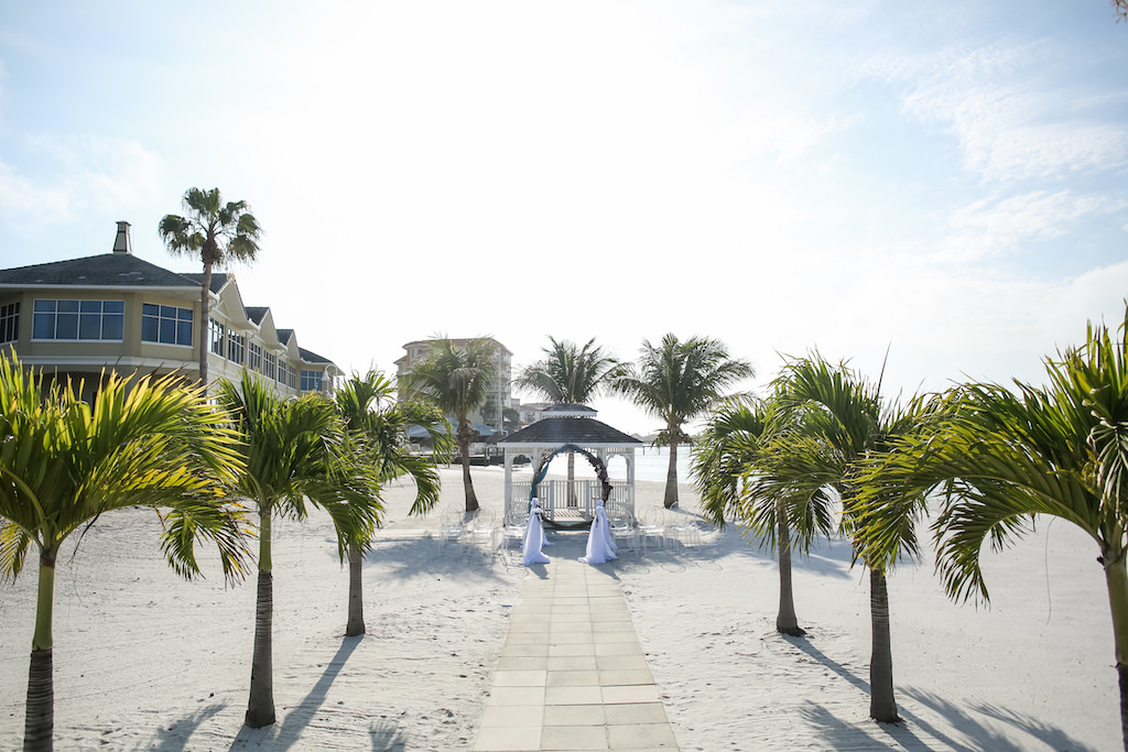Outdoor Beach Wedding Ceremony with Circular Greenery Wedding Arch with White Draping | Tampa Bay Wedding Venue Isla Del Sol Yacht and Country Club