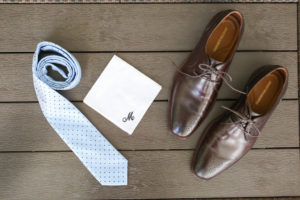 Grooms Wedding Details with Monogramed Handkerchief, Brown Leather Shoes, and Blue Polka Dot Tie