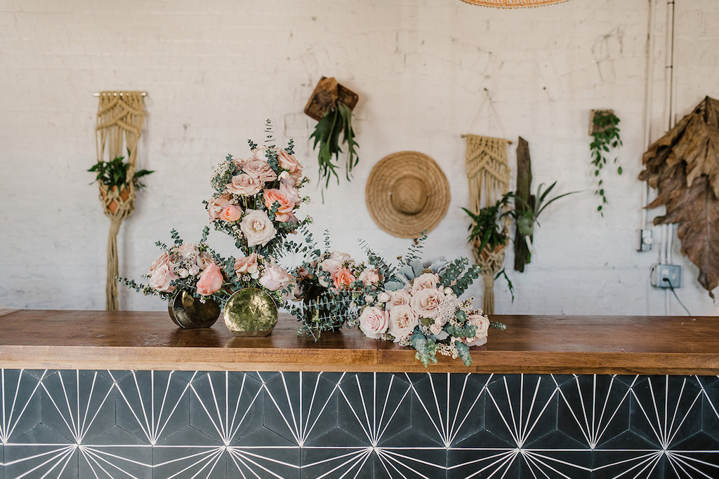 Green and Peach Floral Inspired Tampa Elopement with Rustic Wall Decor, Geometric Counter, and Small Rose and Mismatched Vase Flower Arrangements | Intimate Wedding Venue Fancy Free Nursery