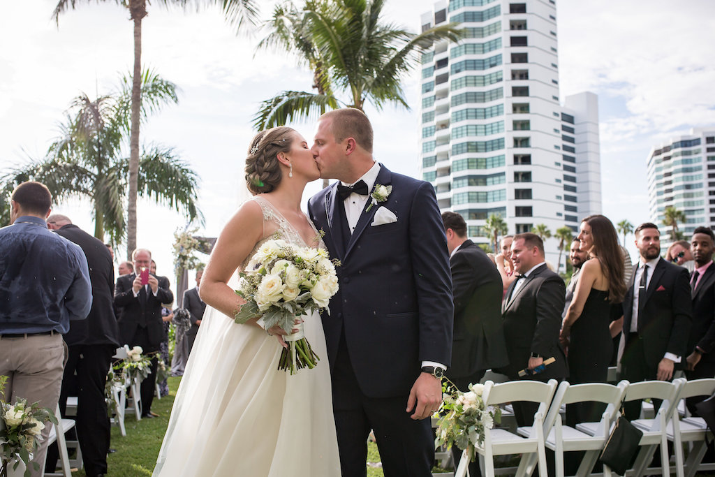 Outdoor Waterfront Downtown Hotel Wedding Ceremony Portrait with White Folding Chairs, Gray Silk Draped Ceremony Arch with White Florals | Sarasota Wedding Venue The Ritz Carlton | Tampa Bay Photographer Cat Pennenga Photography