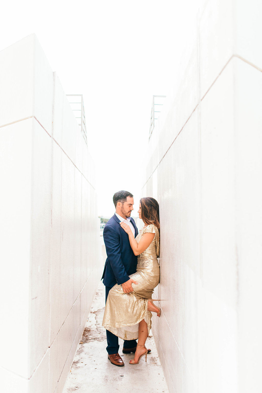 Downtown Tampa Riverwalk Classy Engagement Portrait, Bride in Long Gold Sequin Dress, Groom in Navy Blue Suit with Brown Leather Shoes