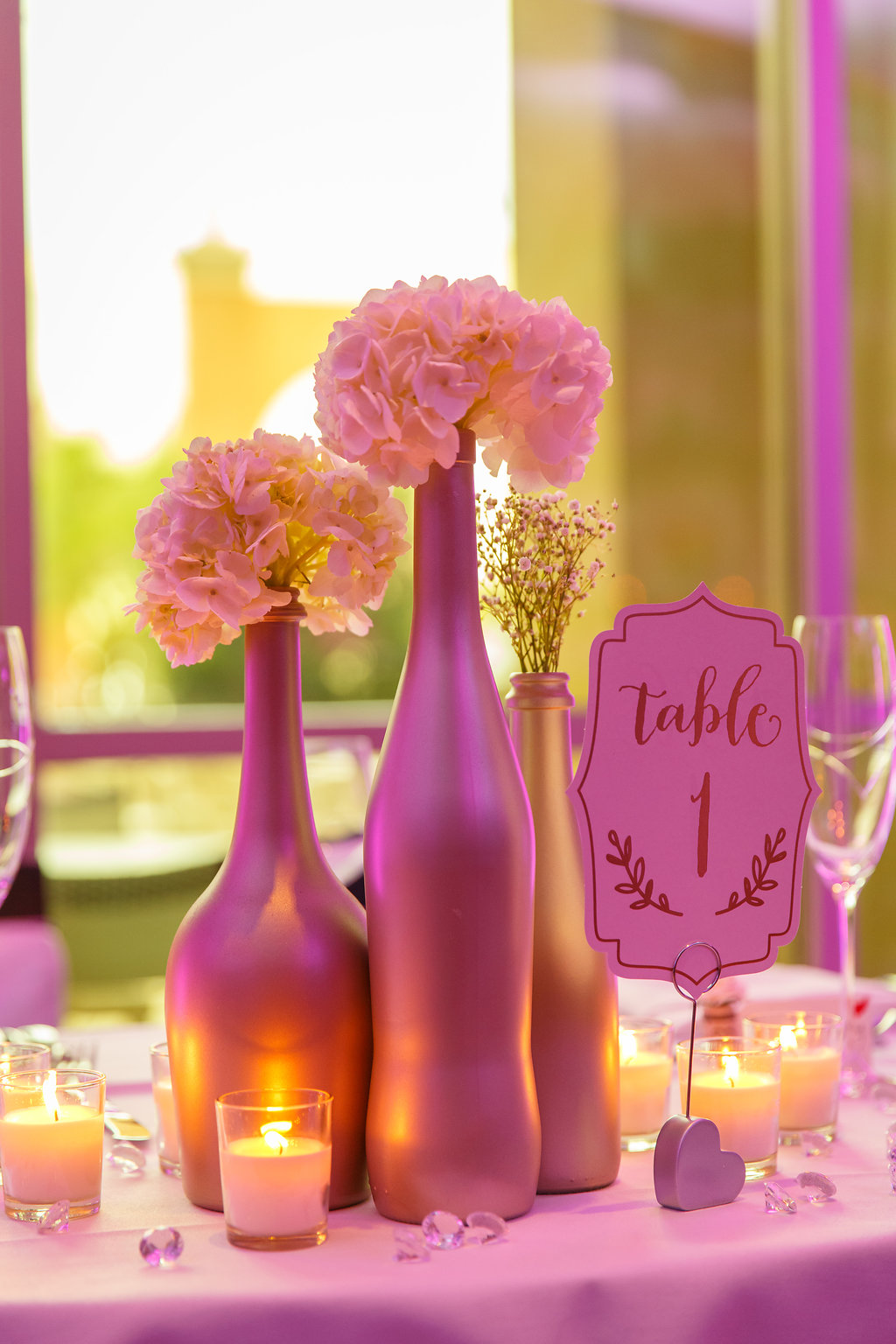 Wedding Reception Metallic Painted Bottle Centerpiece with White Flowers, Votive Candles, and Stylish Gold on White Printed Table Number