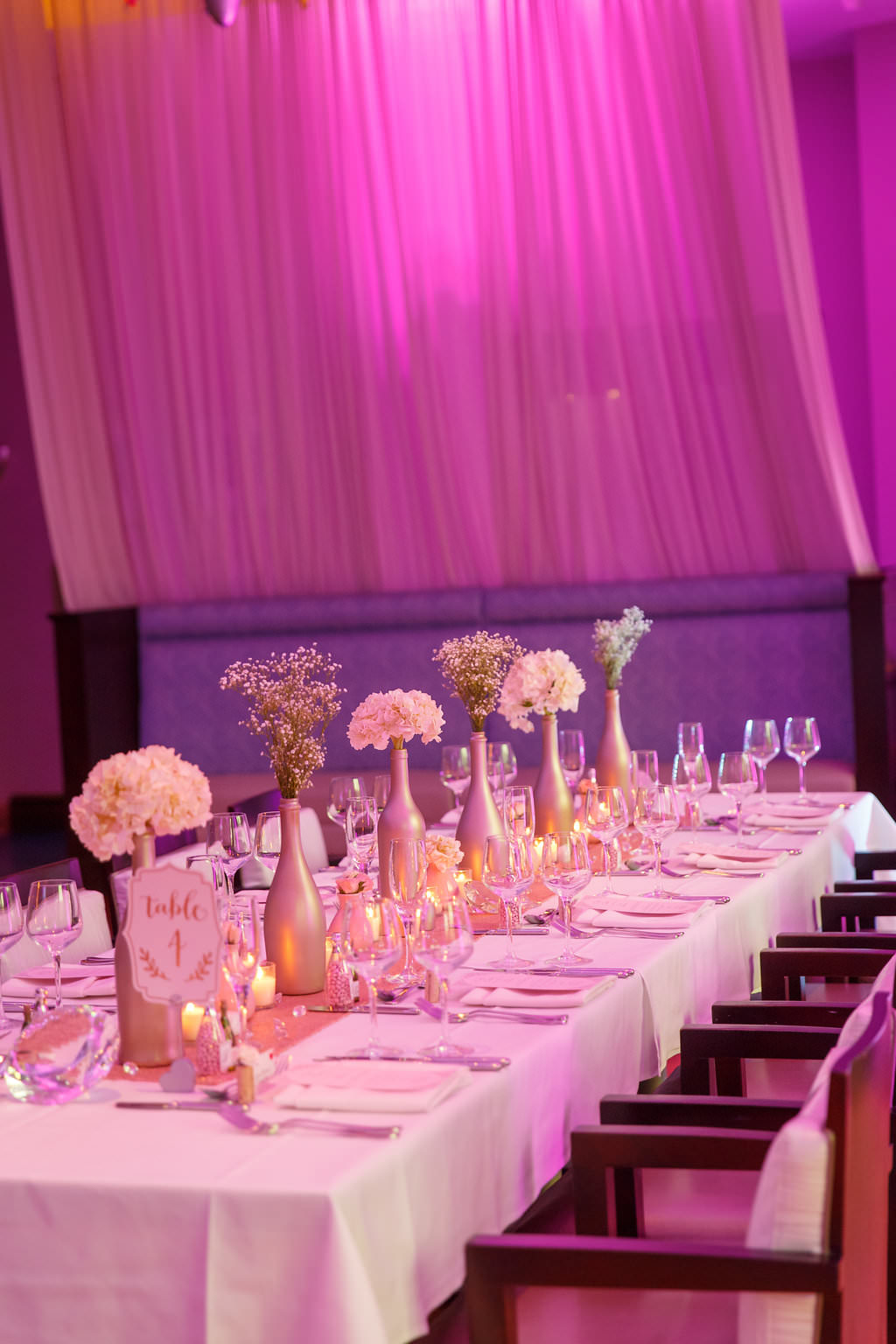 Colorful Indoor Hotel Wedding Reception with Long Feasting Tables, Metallic Painted Bottle Centerpieces on Runner with votive Candles | Venue The Tampa Renaissance