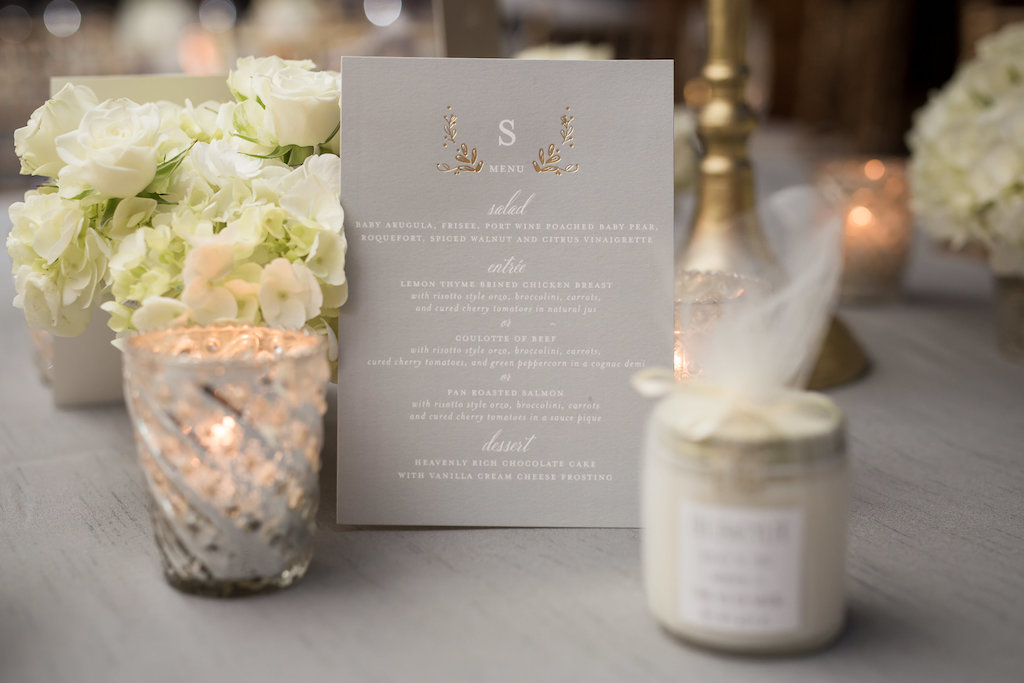 Elegant Wedding Reception Gold Floral Foil and White Script Printed on Gray Wedding Menu, with Jar Favor Wrapped in Fabric, with Small White FLoral Centerpiece and Silver Mercury Votive Candle