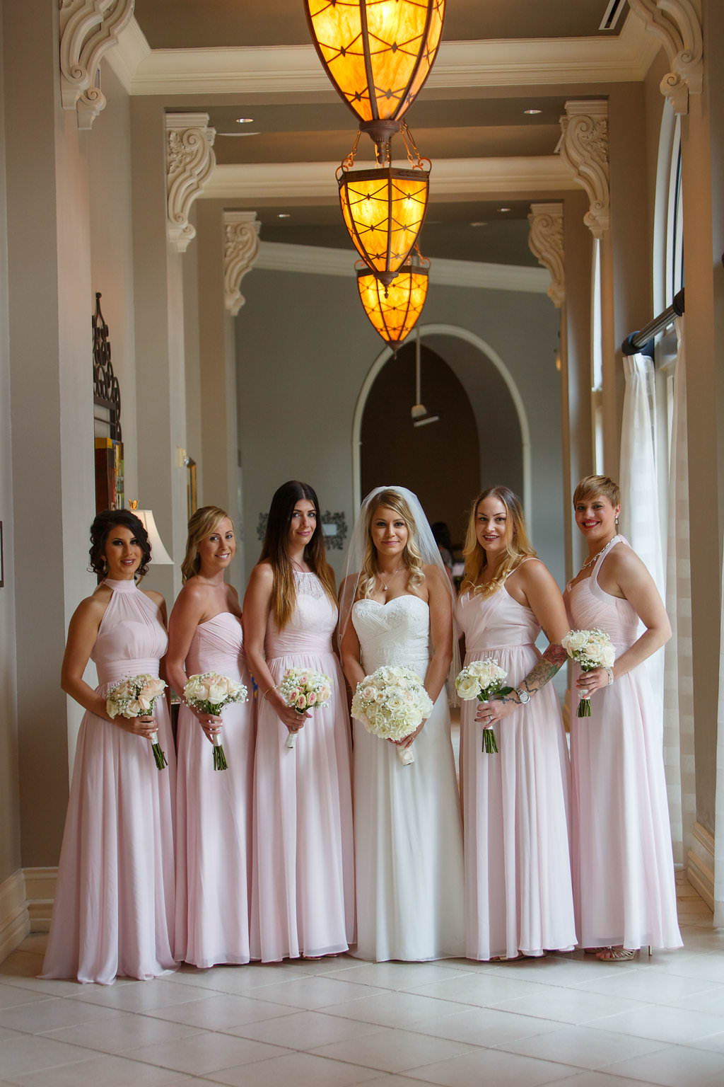 Indoor Bridal Party Portrait, Bride in Strapless Column Wedding Dress, Bridesmaids in Mismatched Blush Pink Floorlength Dresses, with White Floral Bouquets | Hotel Wedding Venue The Tampa Renaissance International