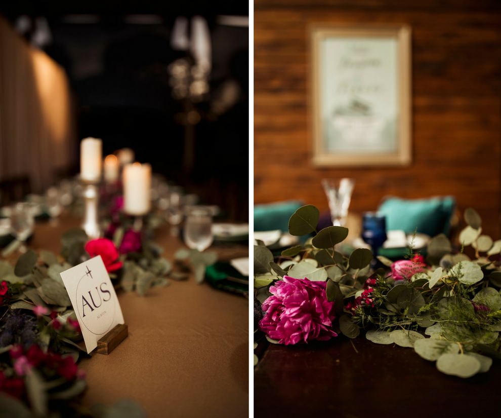 Jewel Toned Wedding Reception with Airport Code Printed Table Numbers, Pillar Candles, Red, Pink and Fuchsia with Greenery Garland Centerpiece, Blue Colored Drinking Glasses, and Turquoise Cushions | Sarasota Wedding Planner Jennifer Matteo Event Planning