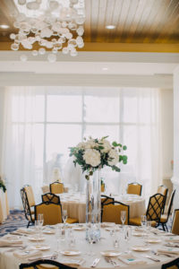 Modern Indoor Hotel Ballroom Wedding Reception with Ivory Rose and White Floral with Natural Greenery Extra Tall Centerpiece in Clear Glass Vase, with Silver Glitter Table Number | Waterfront Hotel Wedding Venue Hyatt Regency Clearwater Beach