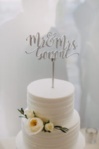 Three Tiered Round White Wedding Cake with White Rose with Greenery and Silver Mr and Mrs Custom Cake Topper | Tampa Bay Hotel Wedding Reception Venue and Caterer Hyatt Regency Clearwater Beach