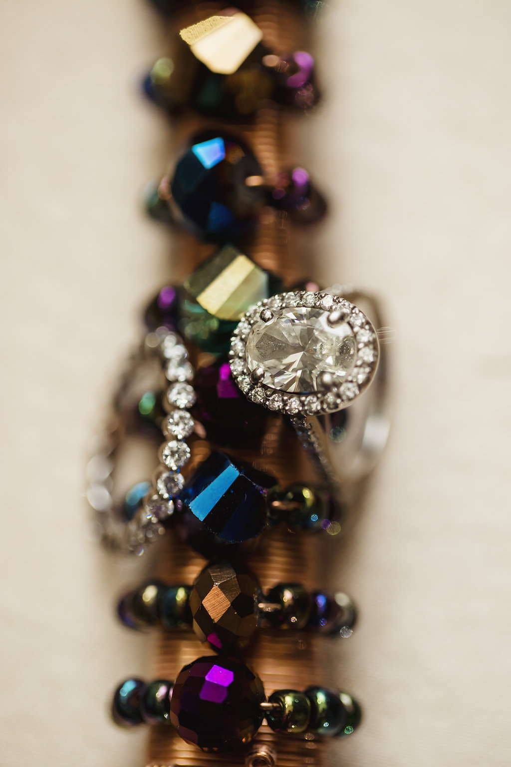 Jewel Tone Wedding Reception Oval Diamond Engagement Ring and Diamond Wedding Band on Decor