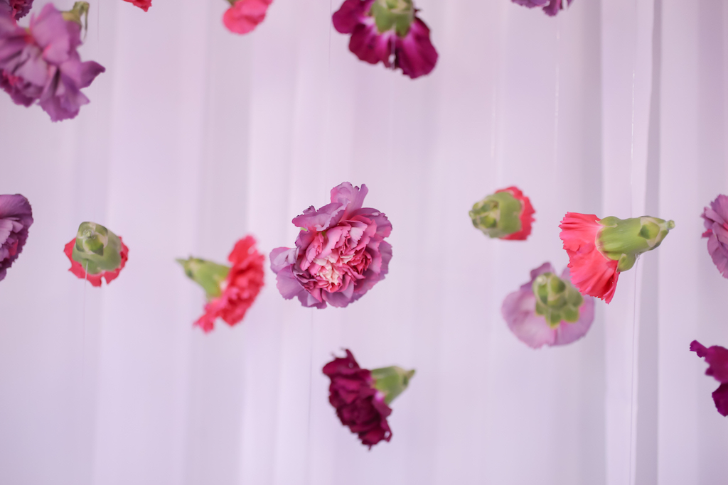 Floral Wedding Decor Detail Hanging Purple, Pink, and Magenta Carnations with White Draping | Tampa Bay Wedding Florist Gabro Event Services