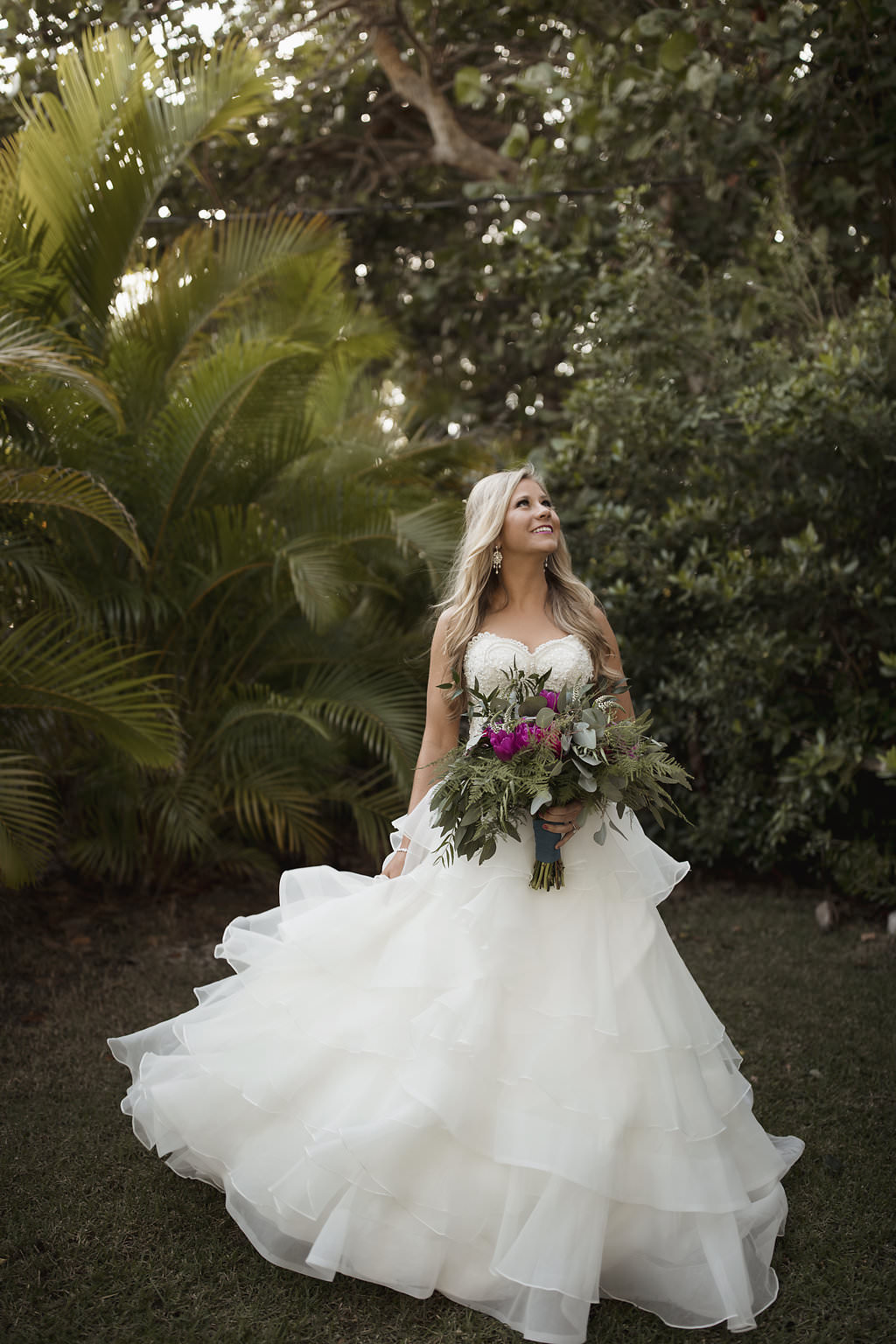 Outdoor Bridal Portrait In Strapless Layered Ballgown Wedding Dress with Fuchsia Floral and Greenery Bouquet Wrapped in Turquoise Ribbon | Jewel Toned Longboat Key Wedding