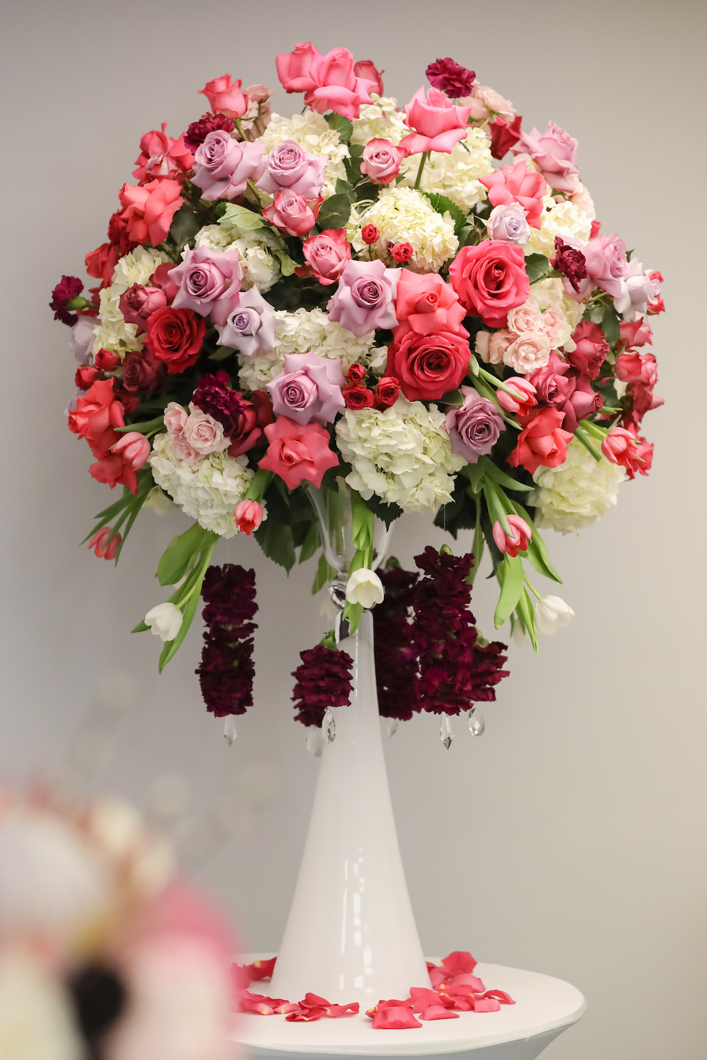 Tall Pink, Red, White with Greenery Round Floral Centerpiece in White Vase, with Hanging Maroon Florals and Crystal Beads | Tampa Bay Wedding Florist Gabro Event Services