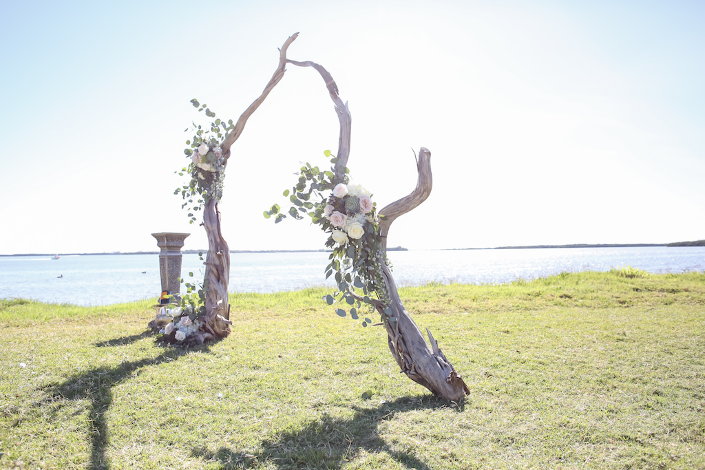 Outdoor Waterfront Wedding Ceremony Organic Driftwood Arch with Blush Pink and White Roses and Natural Greenery | Venue Tampa Bay Watch