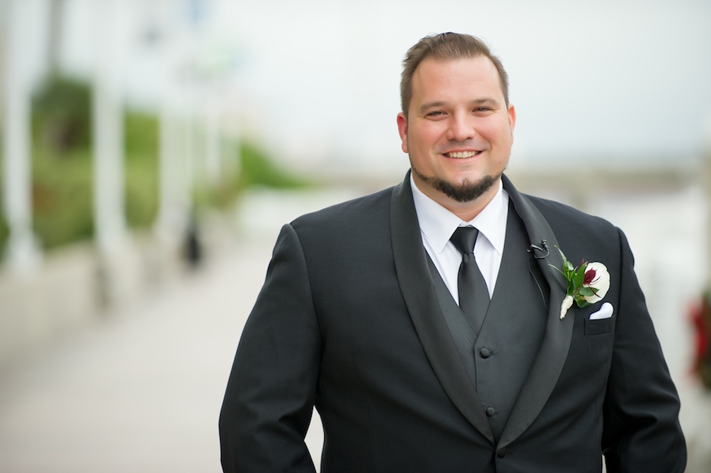 Outdoor Groom Portrait Wearing Black and Gray Suit with White and Dark Red Floral with Greenery Boutonniere | Tampa Wedding Photographer Andi Diamond Photography