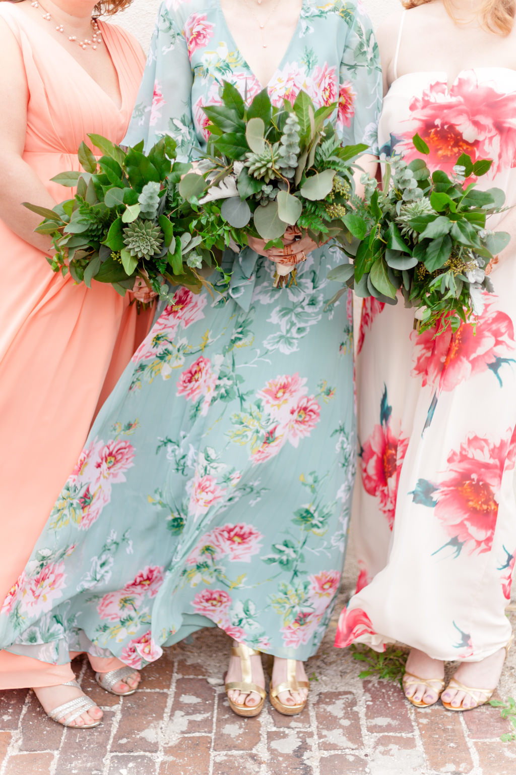 Outdoor Bridesmaid Portrait in Mismatched Peach, Pink and Green Floral Print Dresses with Greenery Bouquets | St Pete Wedding Florist Cotton and Magnolia
