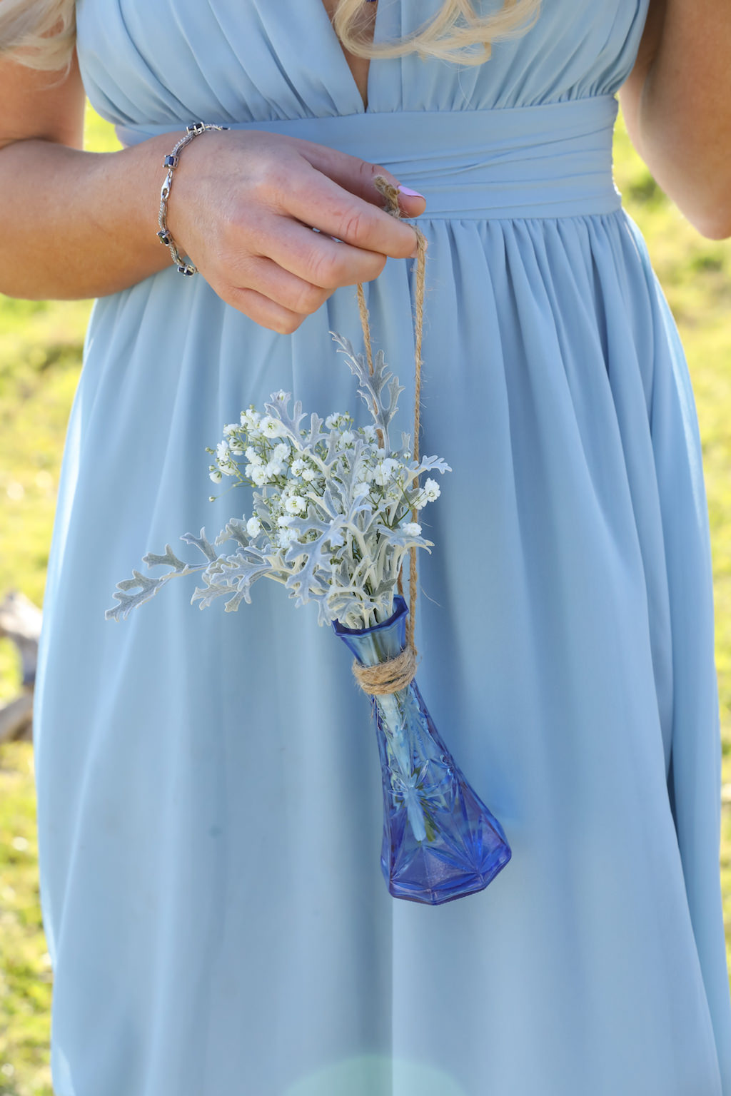 Outdoor Bridesmaid Portrait with Belted Blue Lulus Dress, Blue Glass Bottle with Twine and Greenery and White Flowers | Tampa Bay Wedding Photographer Life Long Studios Photography