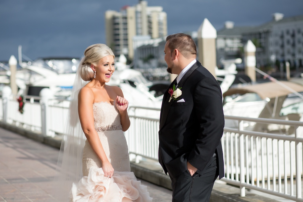 Outdoor Waterfront First Look Portrait, Groom Portrait Wearing Black and Gray Suit with White and Dark Red Floral with Greenery Boutonniere, Bride in Belted Strapless Blush Mermaid Dress | Tampa Wedding Photographer Andi Diamond Photography | Hair and Makeup Michele Renee The Studio