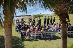 Outdoor Waterfront Wedding Ceremony Portrait with White Folding Chairs, Bridesmaids in Blue Ombre Dresses, Natural Driftwood Arch | Venue Tampa Bay Watch | St Pete Wedding Photographer Lifelong Photography Studio