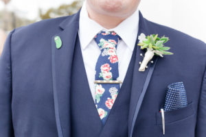 Outdoor Groom Portrait wearing Navy Blue Suit, Succulent Greenery Boutonniere wrapped in White Ribbon, with Polka Dot Pocket Square and Pink Floral Tie | Tampa Bay Wedding Florist Cotton and Magnolia