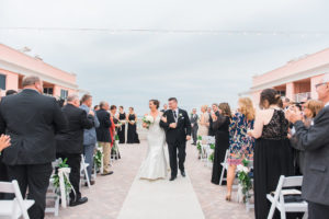 Waterfront Hotel Rooftop Elegant Wedding Ceremony Portrait with White Folding Chairs, White Rose and Greenery Floral Arrangements, and Fabric Aisle | Venue Hyatt Regency Clearwater Beach | Tampa Bay Wedding Planner Special Moments Event Planning | Florist Apple Blossoms Floral Designs | Photographer Kera Photography