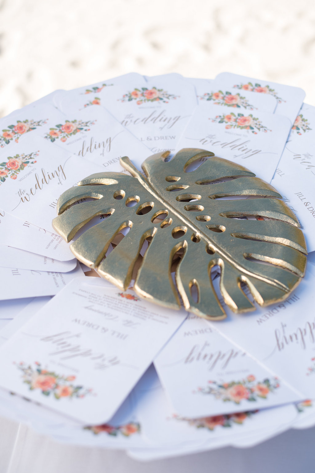 Outdoor Beach Wedding White Square Ceremony Program Fans with Orange Tropical Watercolor Florals and Gold Metal Palm Leaf Paperweight