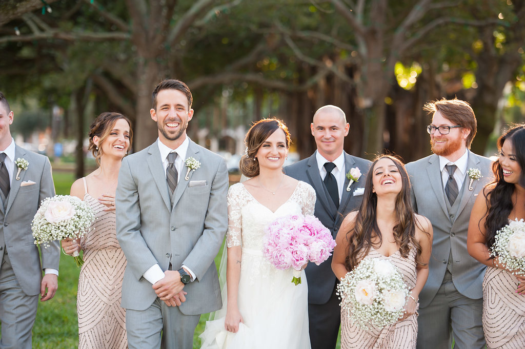 Outdoor Wedding Party Portrait, Groomsmen in Light Gray Suits, Bridesmaids in Blush Beaded Vintage Inspired Adrianna Papell Dress with Baby's Breath and Pink Peony Bouquet, Bride in V Neck Lace Sleeve David's Bridal Dress