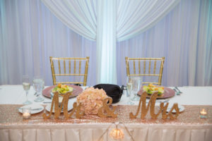 Hotel Ballroom Wedding Reception with White Draping, Rose Gold Sequin Linen, Pink Floral Bouquet, Glitter Mr and Mrs Sign for Sweetheart Table, and Gold Chiavari Chairs and Pink Light Garland | Tampa Bay Wedding Florist and Rentals Gabro Event Services | Venue Tampa Palms Golf and Country Club