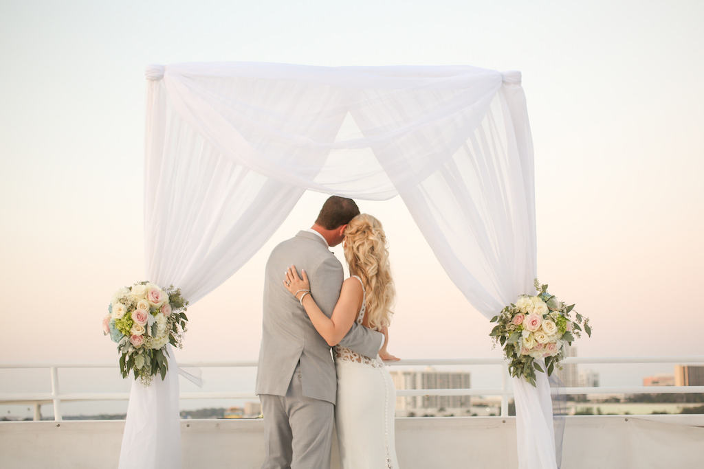Outdoor Waterfront Wedding Ceremony Portrait with White Draping, Blush Pink and White Rose with Greenery Florals | Clearwater Beach Unique Wedding Venue Yacht Starship | Tampa Bay Photographer Lifelong Photography Studios
