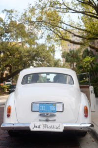 Outdoor Wedding Portrait in Vintage Rolls Royce Car with Hand Painted Black Just Married White Painted Wooden Sign | Tampa Bay Wedding Photographer Marc Edwards Photographs
