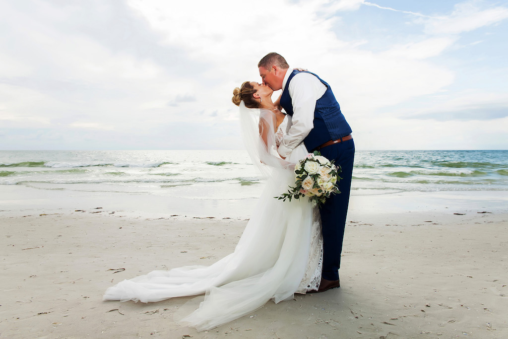 Outdoor Beach Wedding Portrait, Groom in Blue Suit, Bride with Peach and White Floral with Greenery Bouquet | Hotel Wedding Venue Hilton Clearwater Beach