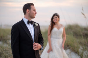 Outdoor Beach Sunset Wedding Portrait, Groom in Black Tux with Bow Tie and White Floral Boutonniere, Bride in Lace Cap Sleeve Belted A Frame Pronovias Dress | Tampa Bay Wedding Photographer Marc Edwards Photographs