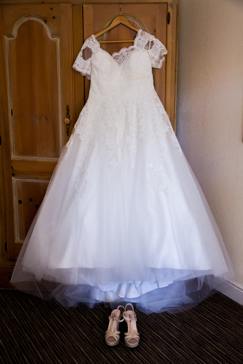 Lace Cap Sleeve Ballgown Pronovias Wedding Dress on Hanger with Rose Gold Peep Toe Platform Wedding Shoes