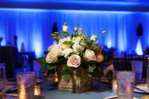 Hotel Ballroom Wedding Reception with Small Pink, White Rose and Greenery Centerpiece in Wooden Box on Blue Table Linen