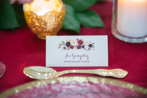 Wine Red and Ivory Rose Watercolor Printed Place Card with Gold Flatware and Red Table Linen | Tampa Bay Wedding Planner Parties A La Carte | Rentals Over The Top Rental Linens