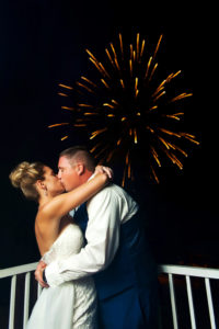 Outdoor Fireworks Nighttime Wedding Portrait, Bride in Strapless Dress Groom in Blue Suit Vest