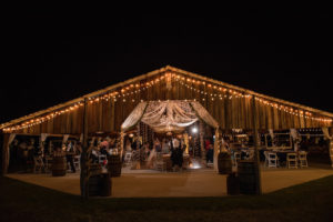 Nighttime Barn Wedding Reception with String Lights and Chandeliers and Antique Barrels | Tampa Bay and Hillsborough County Wedding Venue Wishing Well Barn