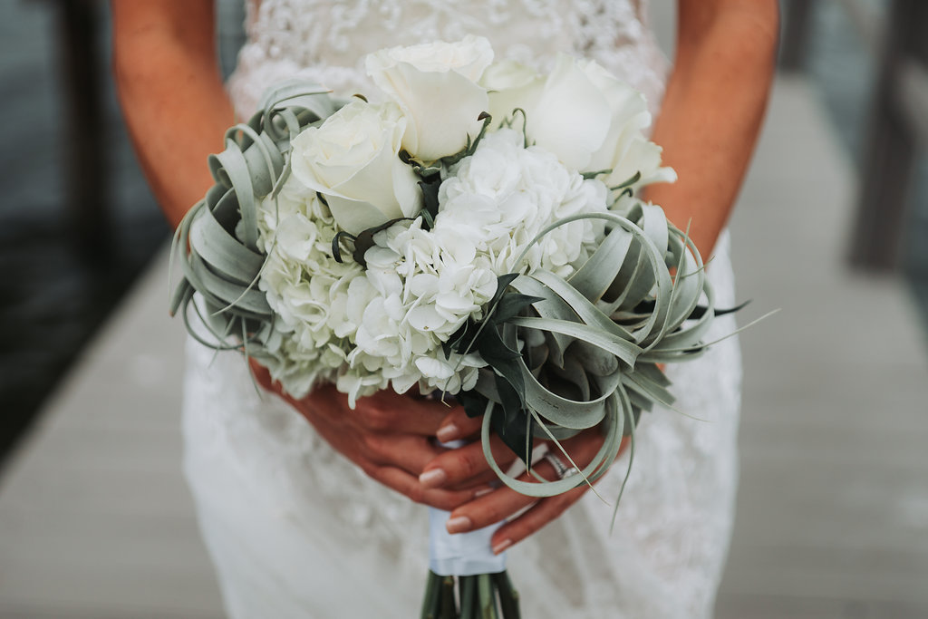 Outdoor Waterfront Bridal Portrait with White Rose and Succulent Greenery Bouquet | Tampa Bay Wedding Photographer Grind and Press Photography | Dunedin Venue Beso Del Sol