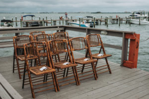 Intimate Waterfront Wedding Ceremony on Dock with Folding Rattan Chairs | Dunedin Wedding Venue Beso Del Sol
