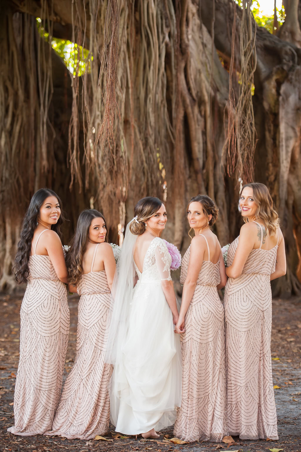Outdoor Bridal Party Portrait with Banyan Trees, Bride in V Back Lace Sleeve Davids Bridal Dress, Bridesmaids in Beaded Column Blush Pink Adrianna Papell Dresses | Downtown St Pete Wedding Cermony Venue North Straub Park