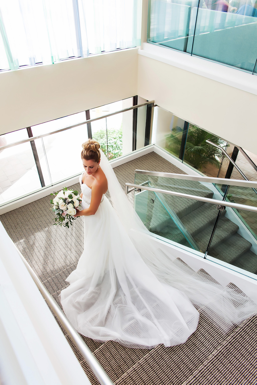 Hotel Interior Bridal Portrait in Strapless Wedding Dress with Long Veil and White and Greenery Bouquet | Tampa Bay Venue Hilton Clearwater Beach