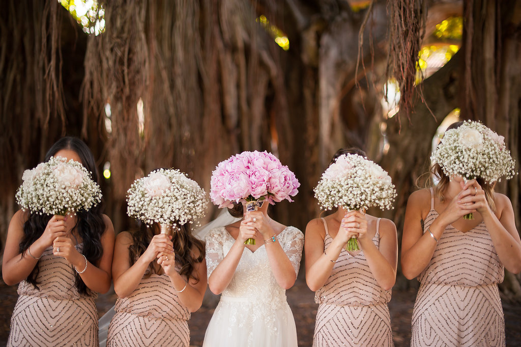 Outdoor Bridal Party Portrait with Banyan Trees, Bride in V Neck Lace Sleeve Davids Bridal Dress, Bridesmaids in Beaded Column Blush Pink Adrianna Papell Dresses with White Babys Breath and Pink Peony Bouquet | Downtown St Pete Wedding Cermony Venue North Straub Park