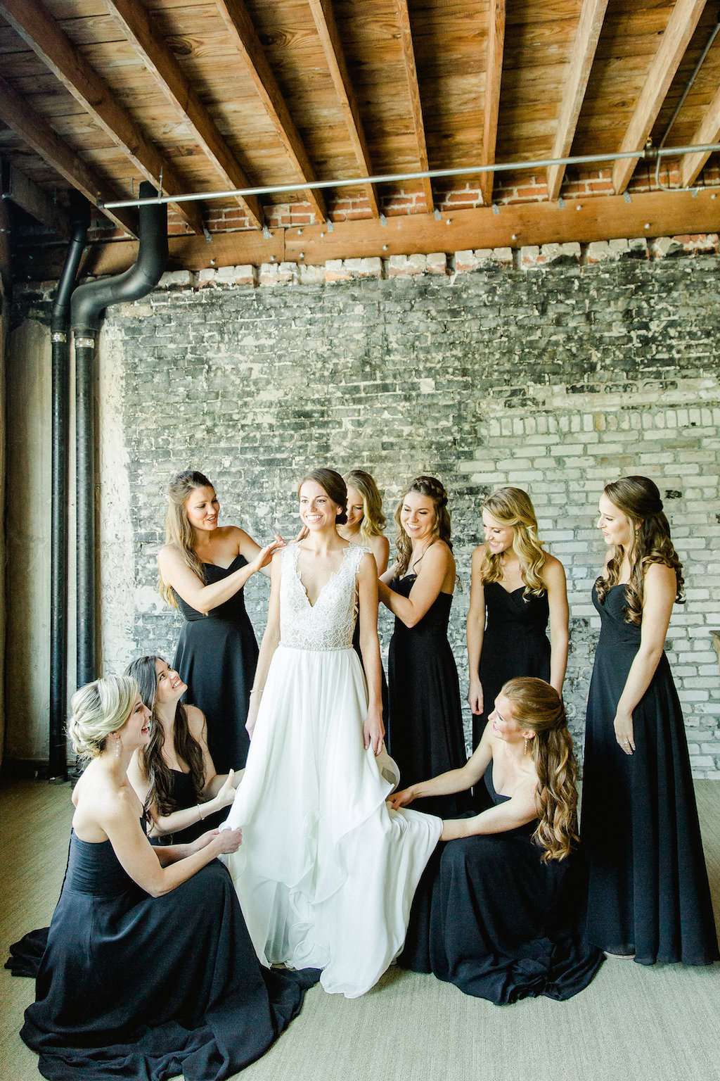 Bridal Party Getting Ready Portrait, Bride in V Neck Lace Bodice Hayley Paige Dress, Bridesmaids in Strapless Floor Length Black Kenneth Winston Dresses | Tampa Bay Wedding Photographer Ailyn La Torre Photography | Venue Oxford Exchange | Hair and Makeup Femme Akoi Beauty Studio