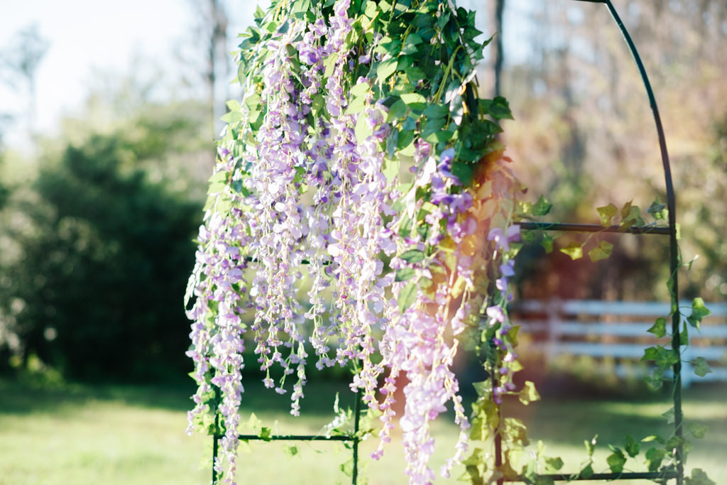 Outdoor Farm Wrought Iron Wedding Ceremony Arch with Hanging Purple Lilac Floral and Greenery