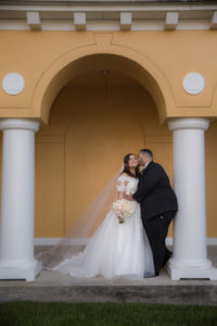 Outdoor Wedding Ceremony Portrait, Bride in Ballgown Off the Shoulder Pronovias Dress with Pink and White Floral Bouquet, Groom in Black Suit | Wedding Venue Tampa Palms Golf and Country Club
