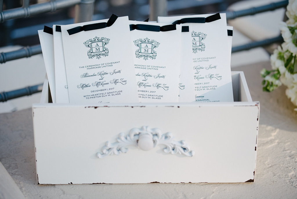 Elegant Blue Script Printed on White Long Rectangle Wedding Ceremony Programs with Custom Monogram and Navy Ribbon in Vintage Drawer | Sarasota Wedding Stationery and Paper Goods URBANcoast